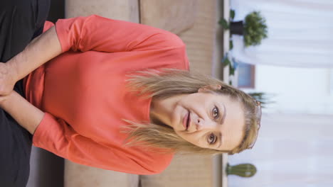 Vertical-video-of-Woman-looking-at-camera-with-curious-expression.